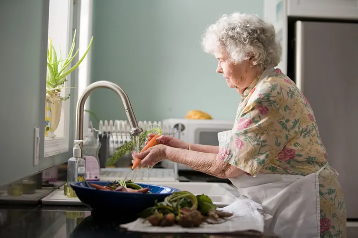 Senior neighbor cooking at home